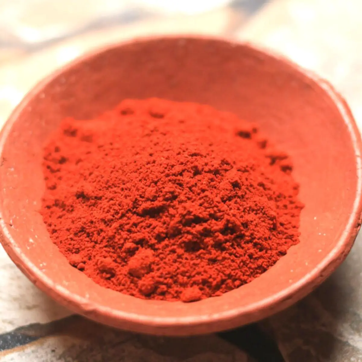 A bowl with bottle masala spice mix.