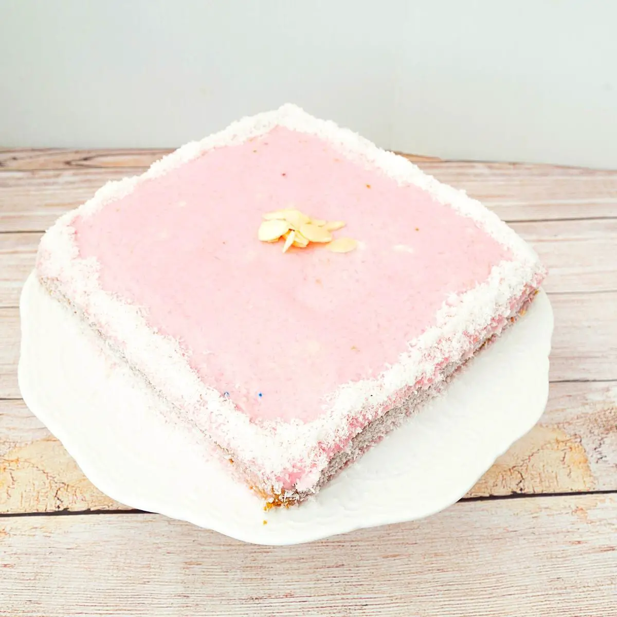 A square cake frosted with sugar glaze.