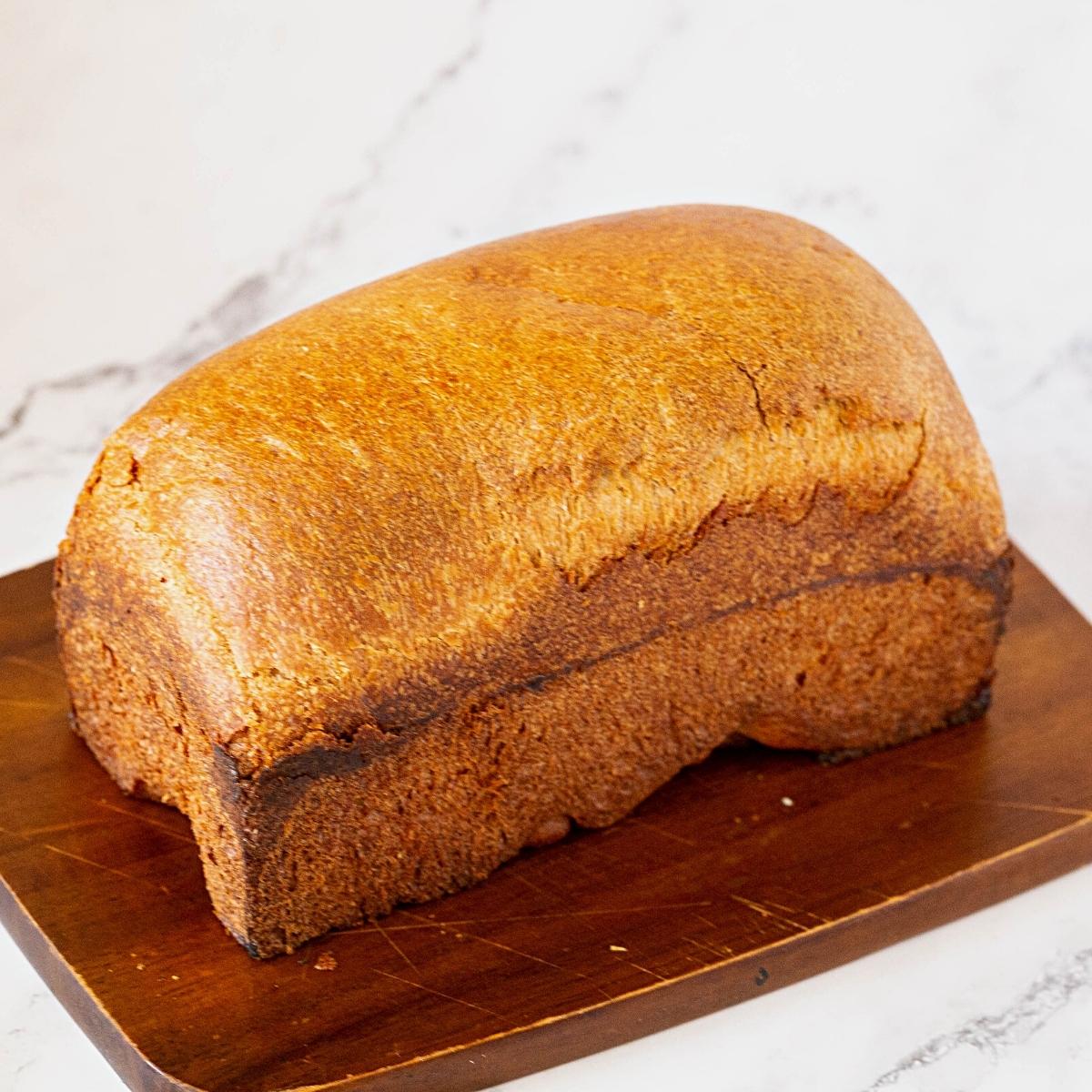 A loaf on a wooden board.