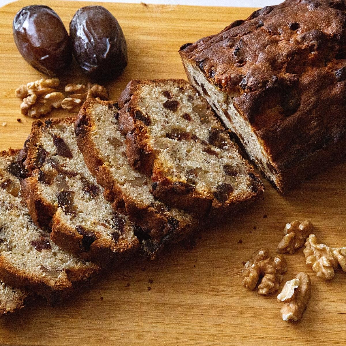 Wooden board with date and walnut cake.