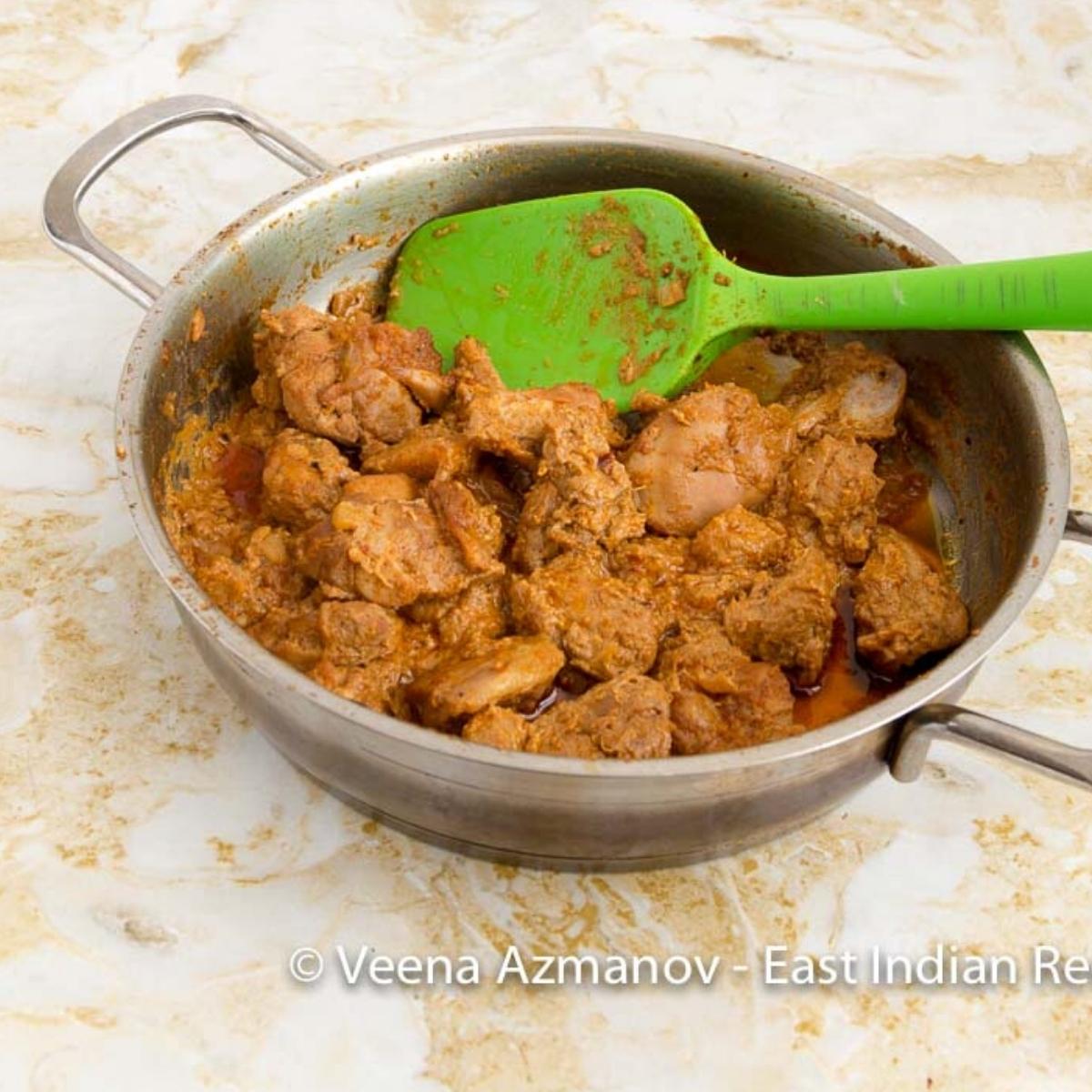 A skillet with chicken curry.