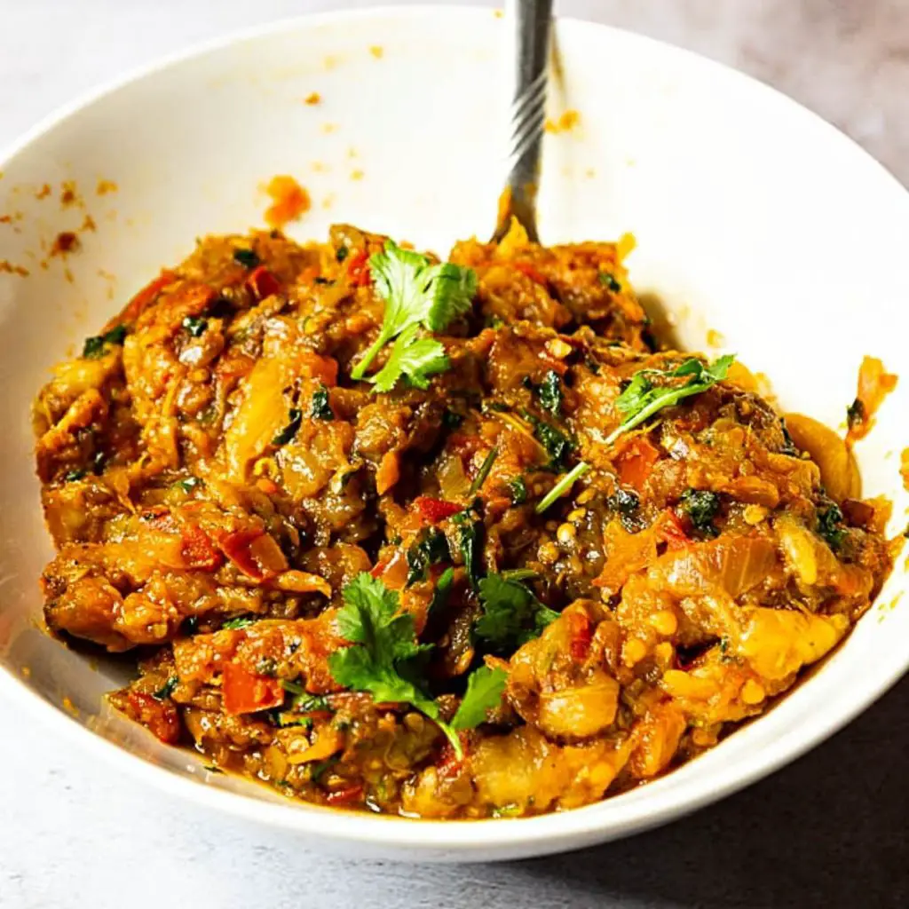 A bowl with roasted eggplant and bharta.