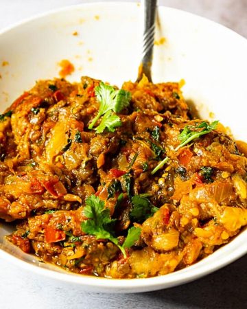 A bowl with roasted eggplant and bharta.