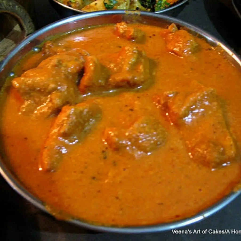 A bowl with butter chicken.