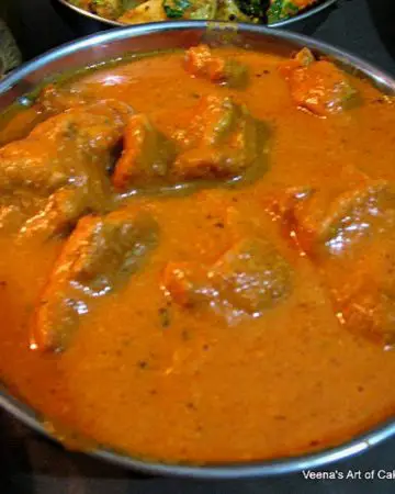 A bowl with butter chicken.