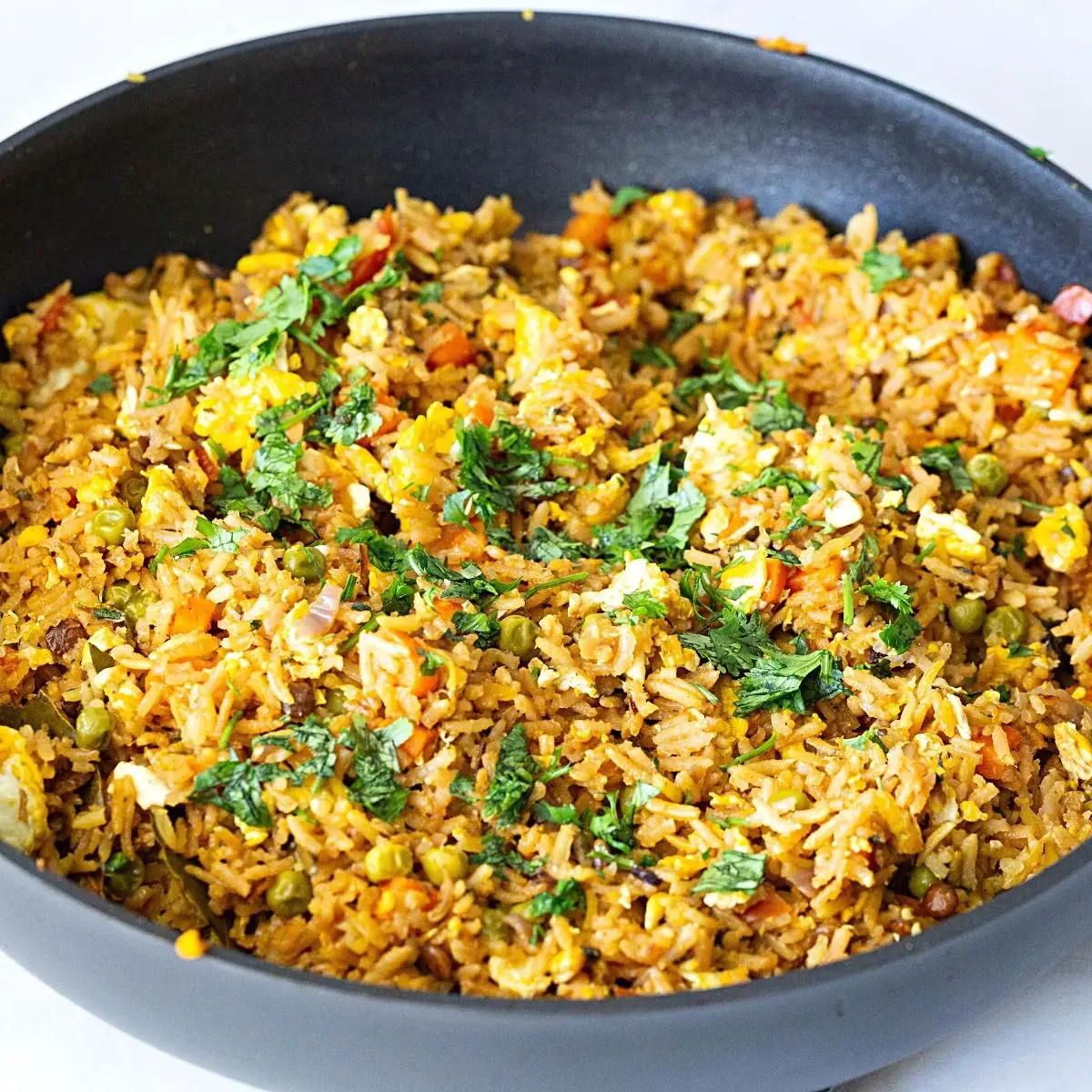 A skillet with fried rice. 