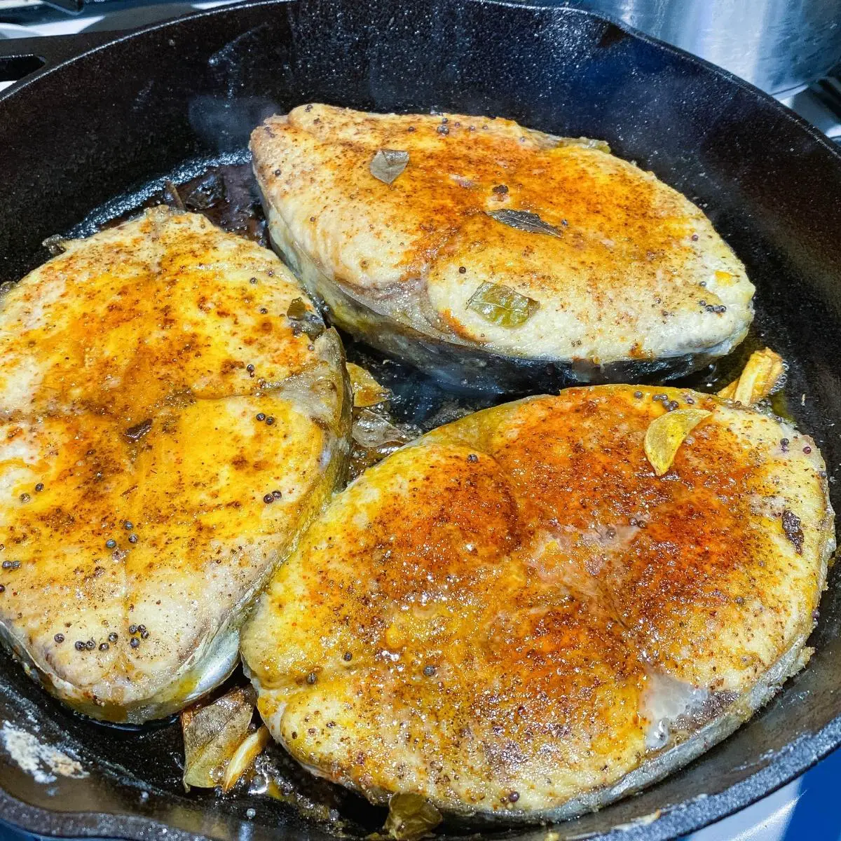 A cast iron skillet with fish.