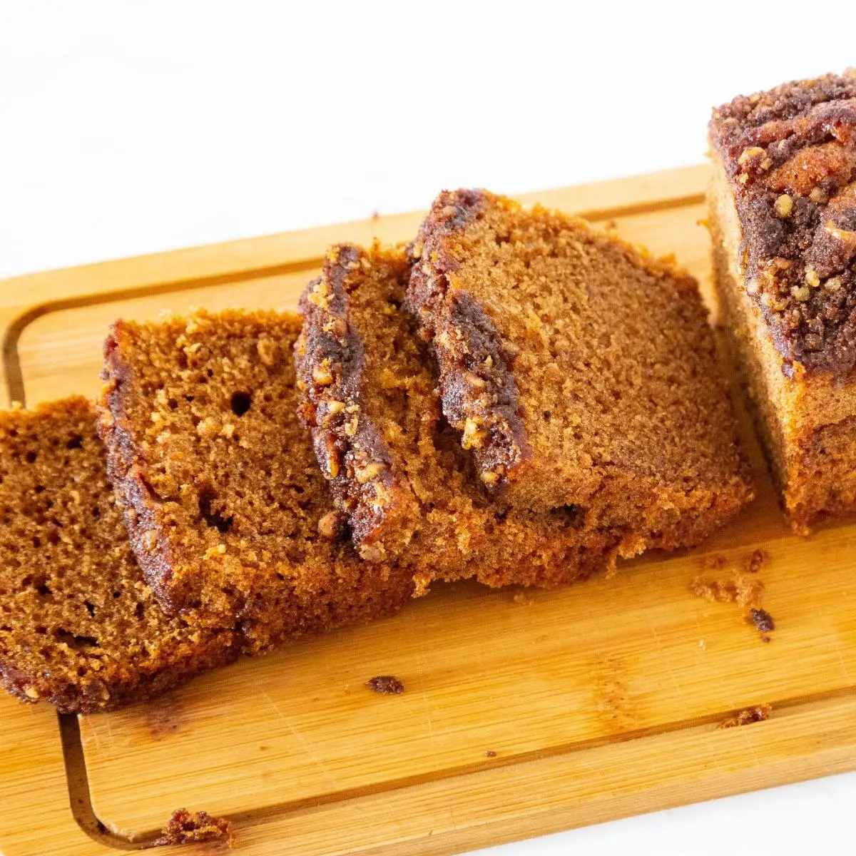 Sliced coffee cake on a wooden board. 