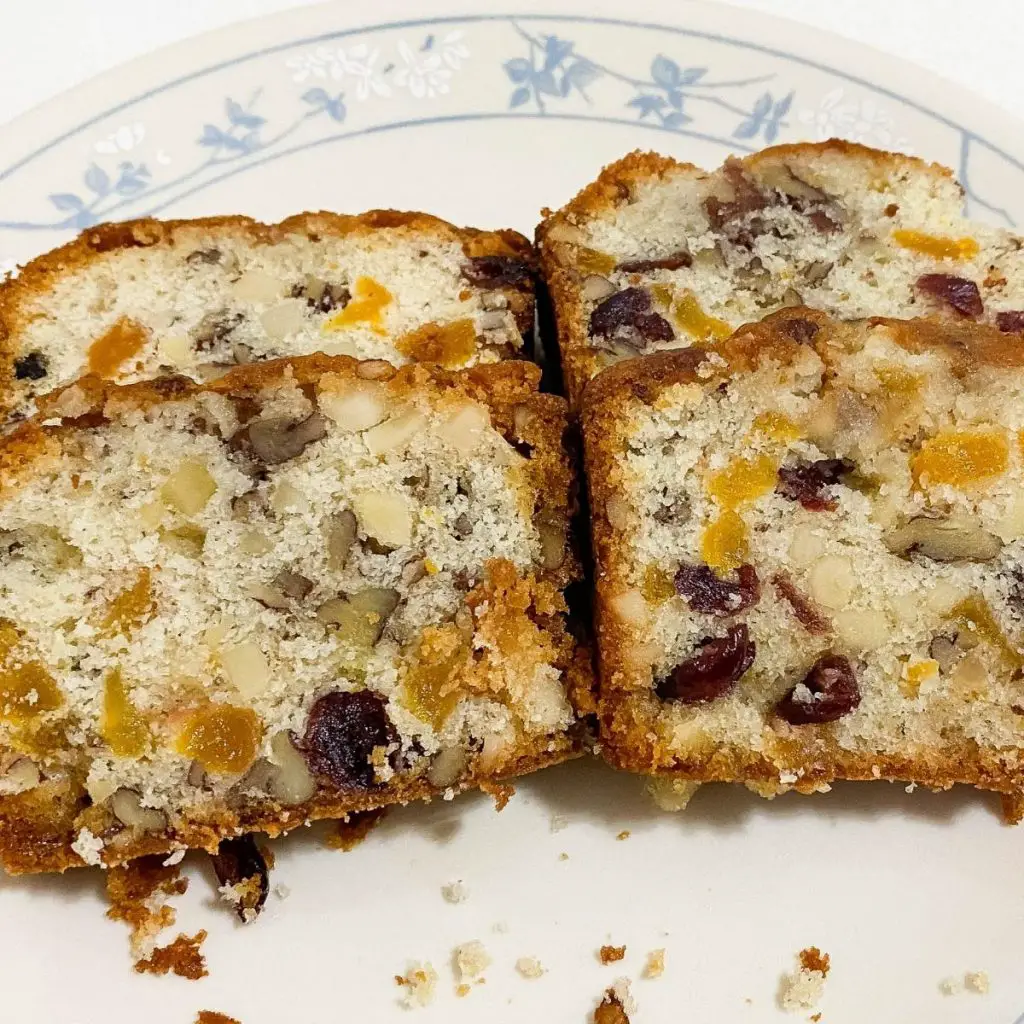 A plate with fruitcake with marzipan.