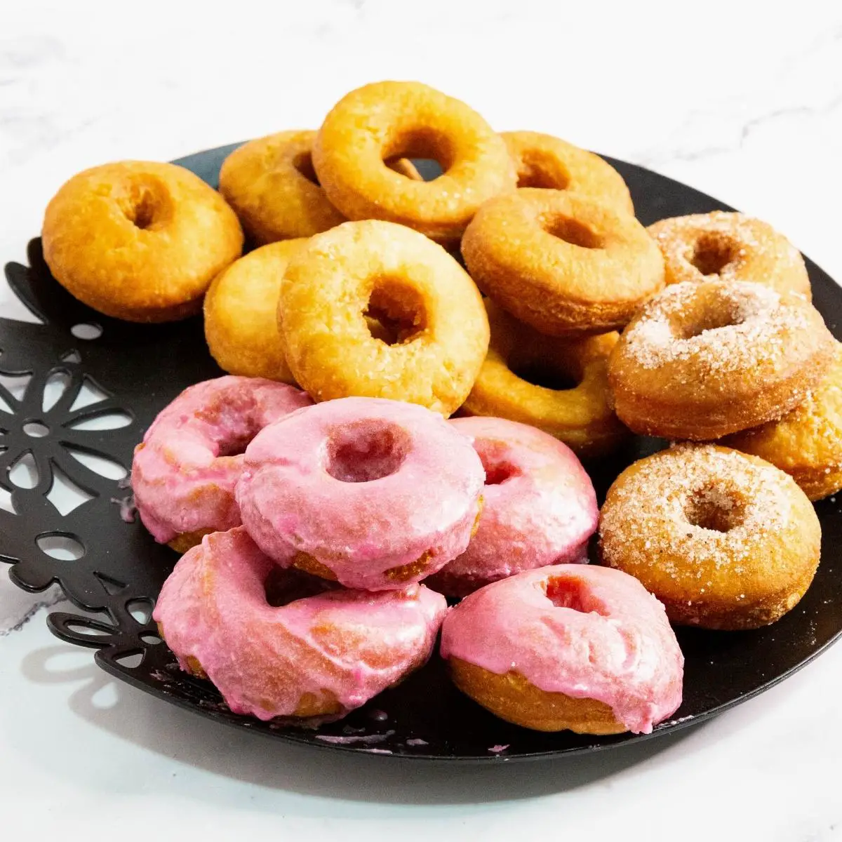 A plate with sugar glazed donuts.