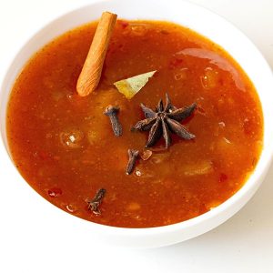 A white bowl with mango murabba pickle.