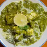 A bowl with green spinach gravy.