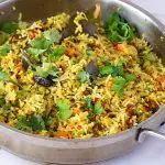 A skillet with green pulao.