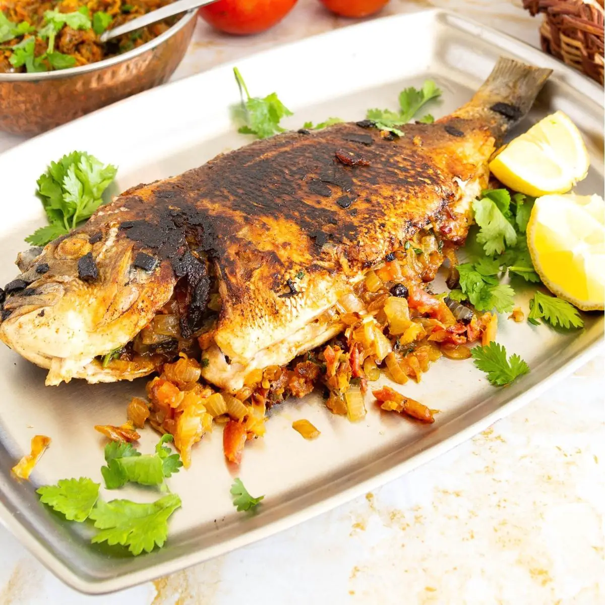 A tray with pan fried fish.