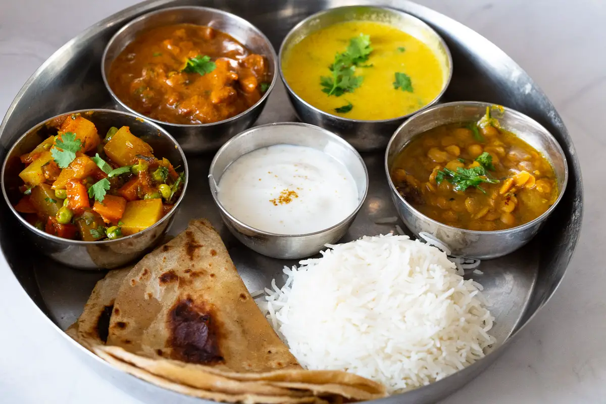 A thali with a few vegetarian dishes.