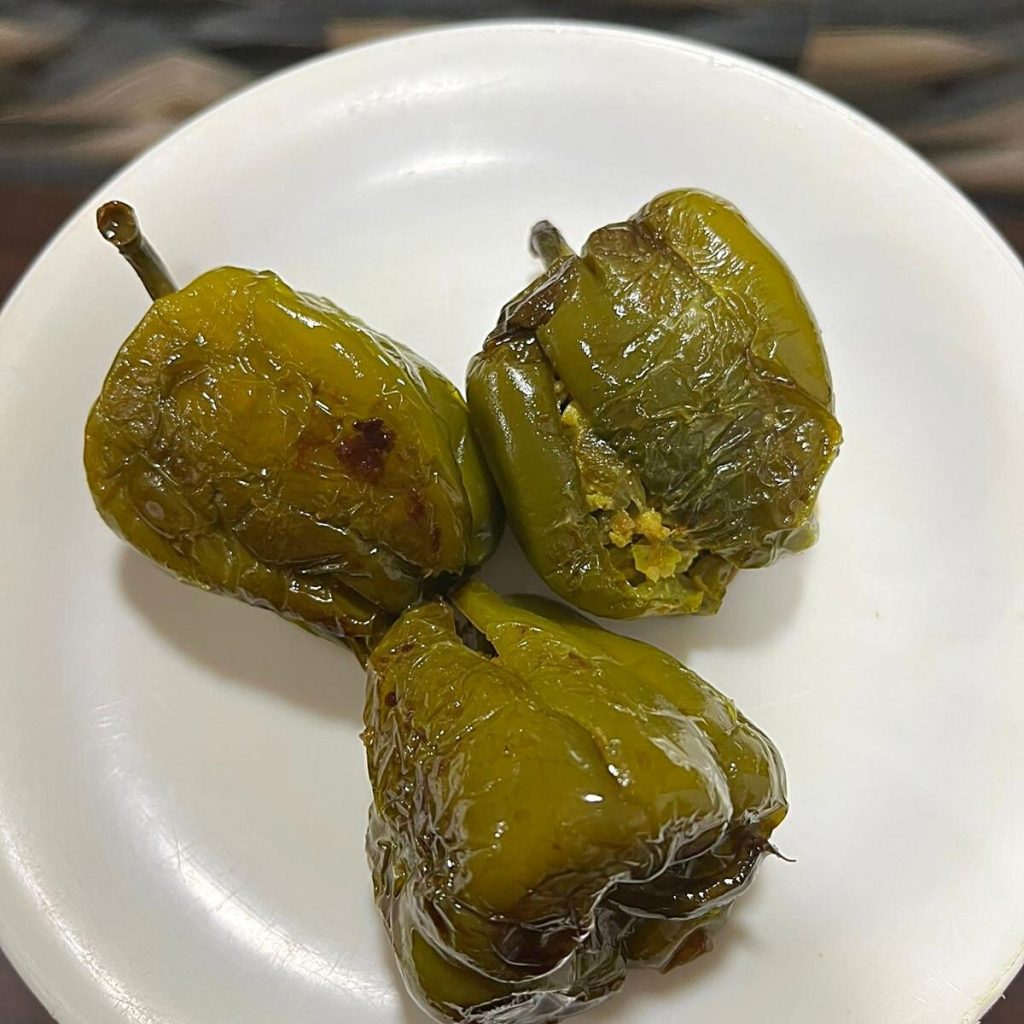 Green stuffed peppers in a plate.
