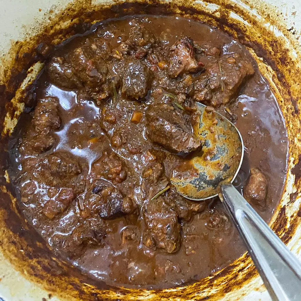 A pot with goan curry with mutton masala.