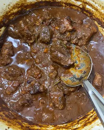 A pot with goan curry with mutton masala.