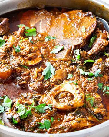 A skillet with beef shanks in curry.