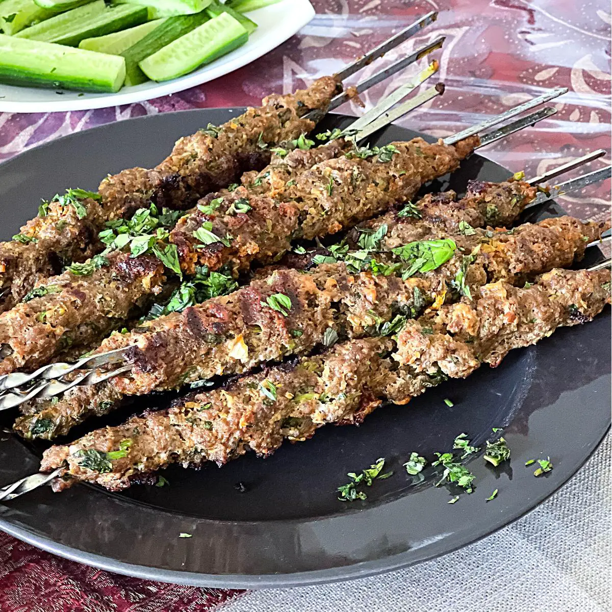 A plate with ground beef kebabs.