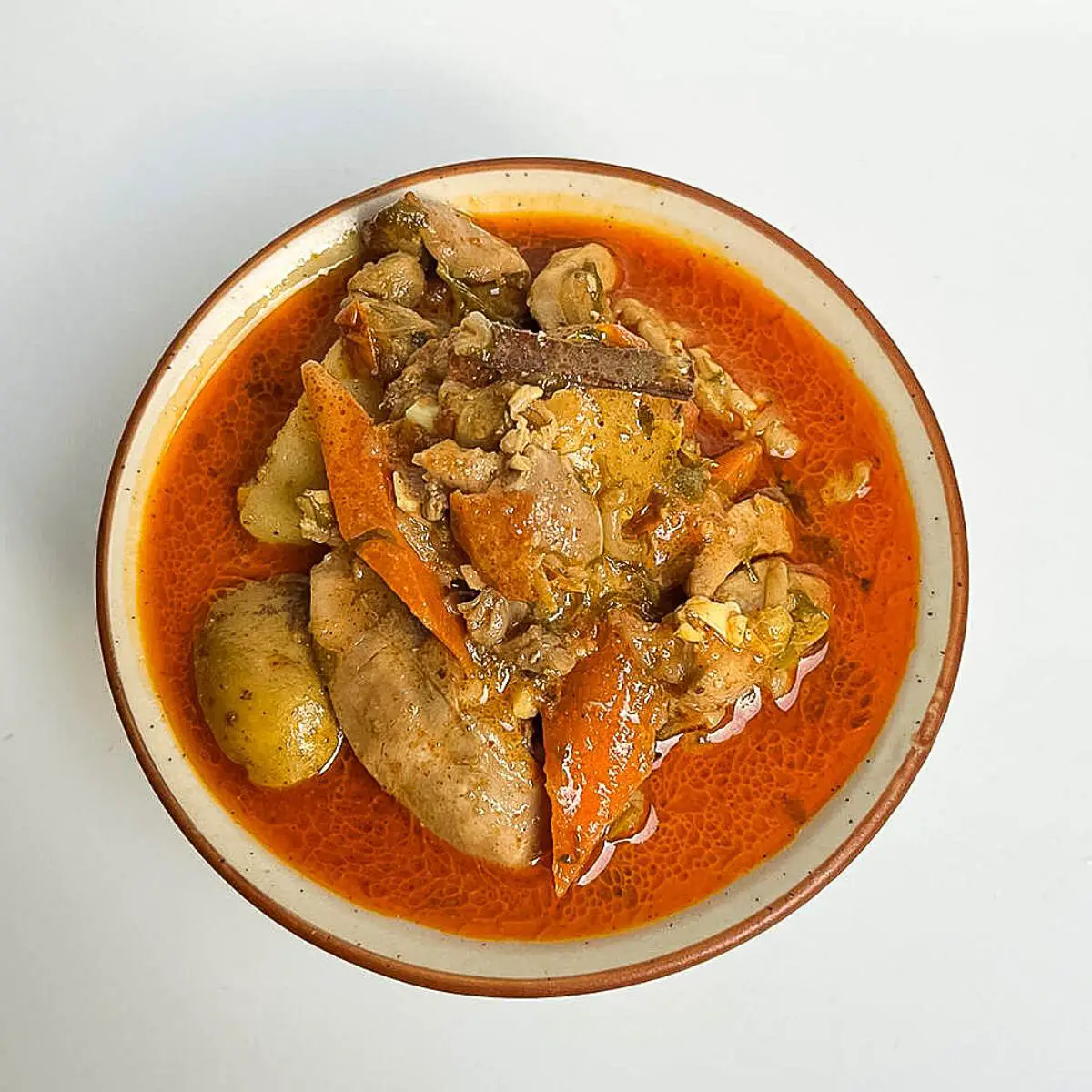 A bowl with curry coconut chicken.