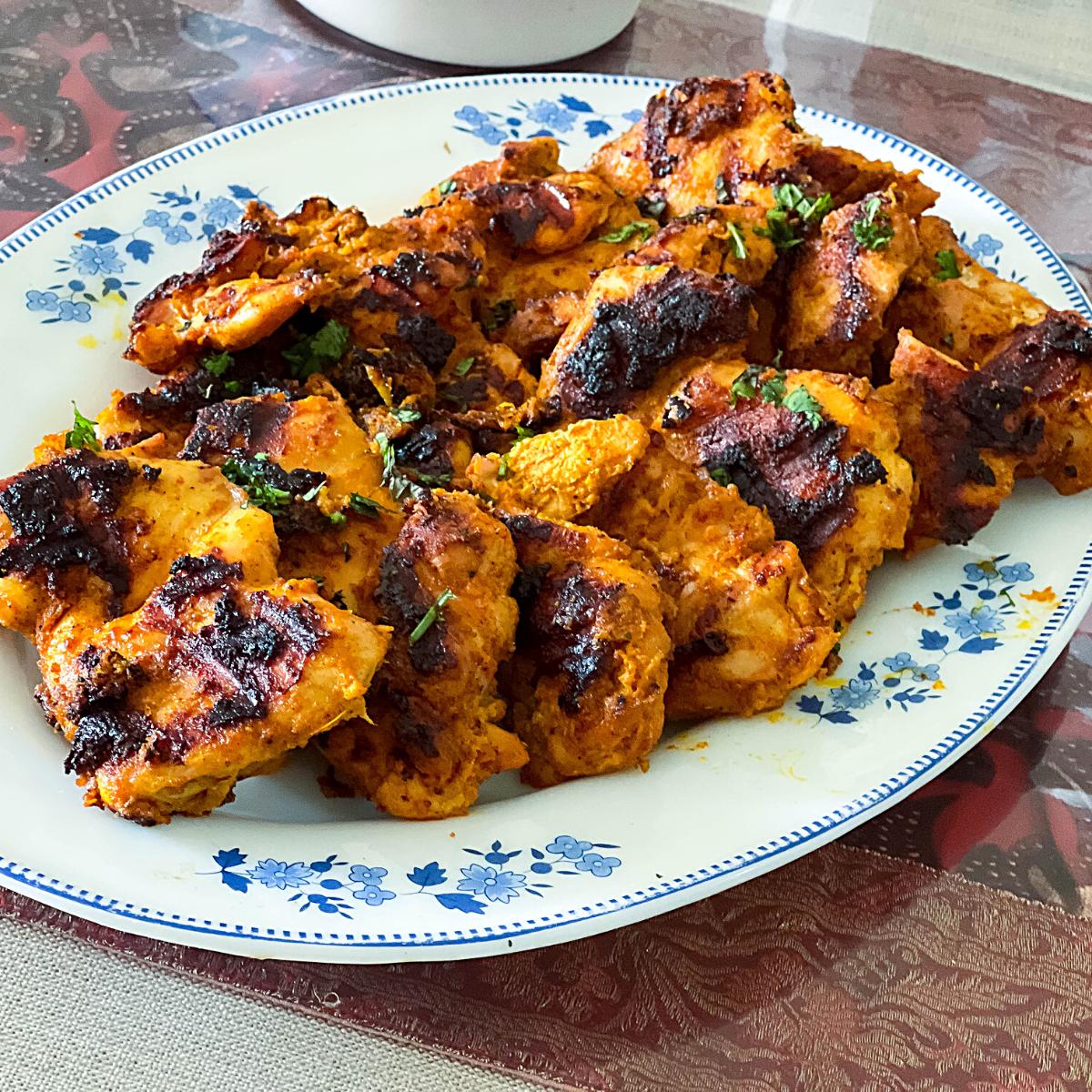 A platter of grilled tandoori chicken.