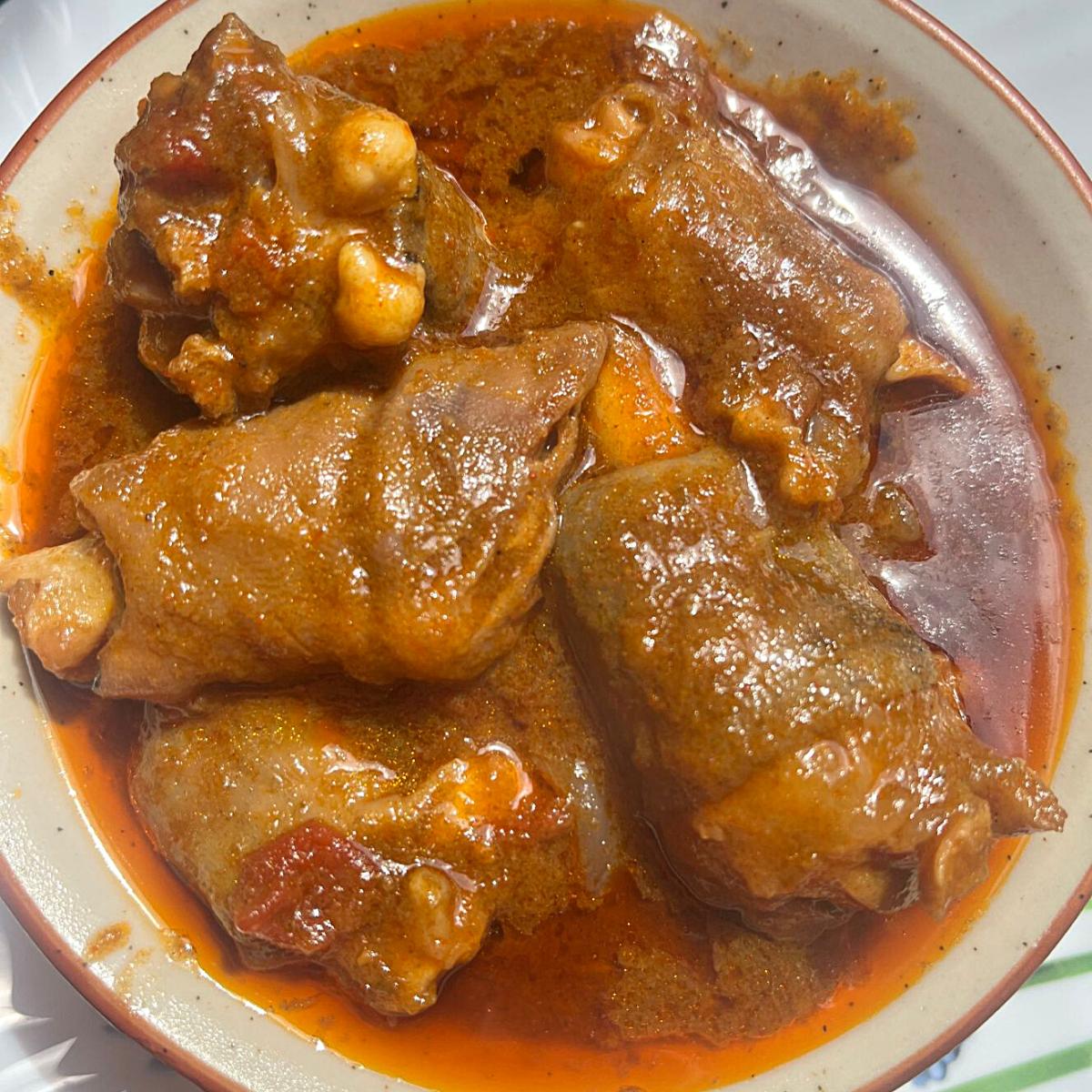 A bowl with goat curry trotters.